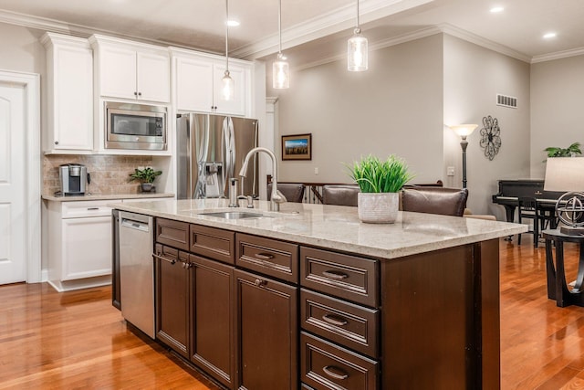 5464 Slater Rdg, Westerville, OH 43082 - kitchen with stainless steel appliances, ornamental molding, light wood-style flooring, tasteful backsplash, and recessed lighting
