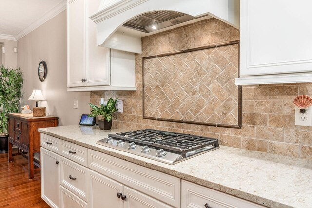 5464 Slater Rdg, Westerville, OH 43082 - kitchen featuring stainless steel gas stovetop, custom range hood, crown molding, white cabinetry, and light stone counters