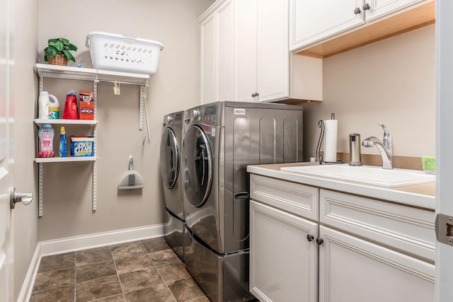 5464 Slater Rdg, Westerville, OH 43082 - washroom with washer and clothes dryer, baseboards, cabinet space, and stone finish flooring