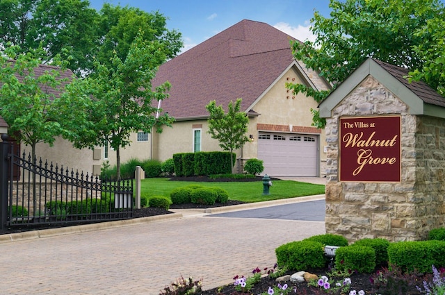 5464 Slater Rdg, Westerville, OH 43082 - view of front of property with fence, stone siding, stucco siding, a garage, and driveway