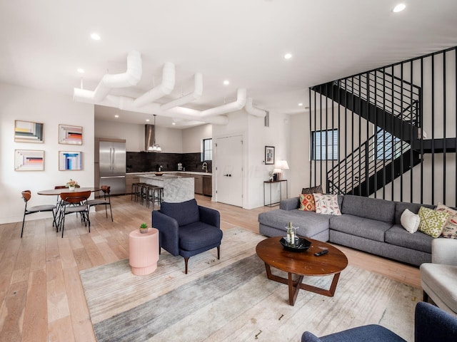 460 S Lane Unit 460, Columbus, OH 43206 - living room featuring recessed lighting, light wood-type flooring, stairs, and baseboards