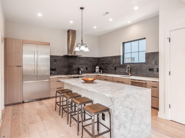 460 S Lane Unit 460, Columbus, OH 43206 - kitchen with stainless steel appliances, wall chimney exhaust hood, modern cabinets, a sink, and a center island