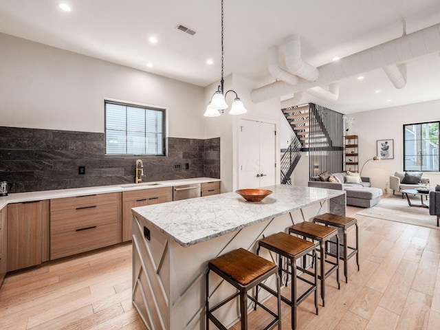 460 S Lane Unit 460, Columbus, OH 43206 - kitchen featuring a kitchen breakfast bar, a center island, light wood-style floors, recessed lighting, and a sink
