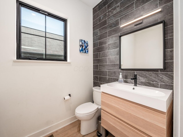 460 S Lane Unit 460, Columbus, OH 43206 - half bath featuring vanity, baseboards, wood finished floors, toilet, and tile walls