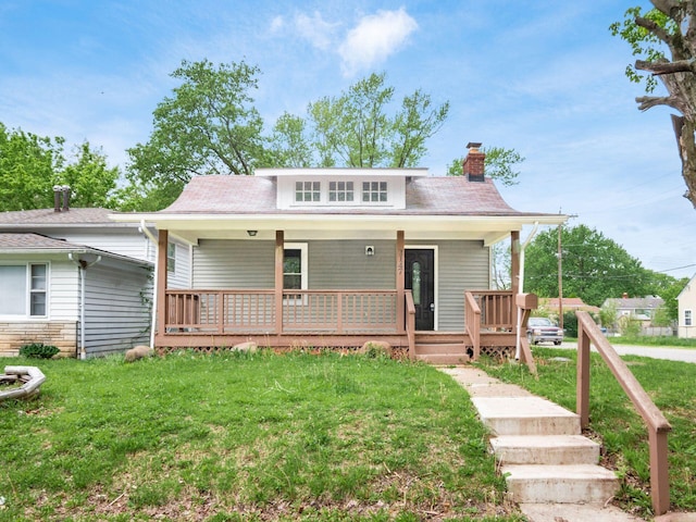 3147 Grasmere Ave, Columbus, OH 43224 - bungalow-style house featuring a chimney, a porch, and a front lawn