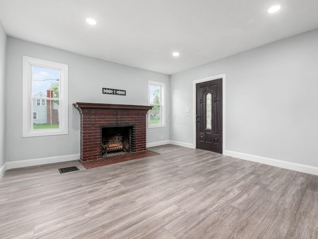 3147 Grasmere Ave, Columbus, OH 43224 - unfurnished living room with visible vents, light wood-style flooring, baseboards, and recessed lighting