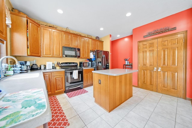 12094 Beech Tree Ct S, Thornville, OH 43076 - kitchen featuring black appliances, a sink, light countertops, a kitchen island, and light tile patterned floors