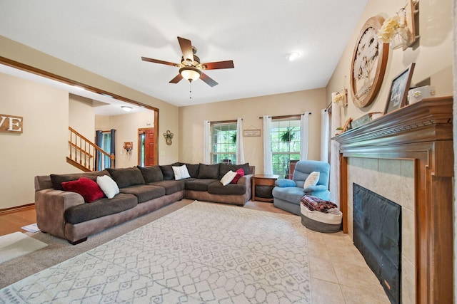 12094 Beech Tree Ct S, Thornville, OH 43076 - living area featuring a tile fireplace, ceiling fan, and stairway