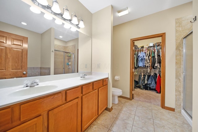 12094 Beech Tree Ct S, Thornville, OH 43076 - full bathroom with a stall shower, a spacious closet, double vanity, tile patterned floors, and toilet