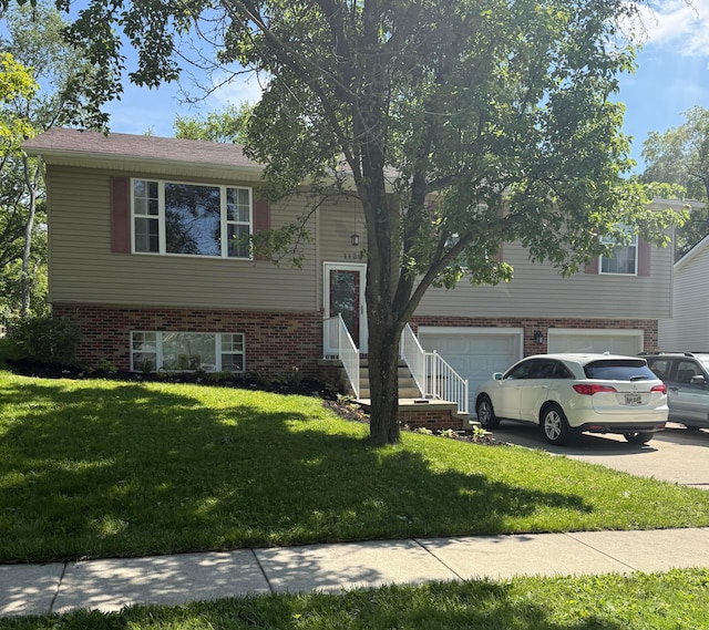 1129 Coventry Cir, Lancaster, OH 43130 - raised ranch with an attached garage, a front yard, brick siding, and driveway