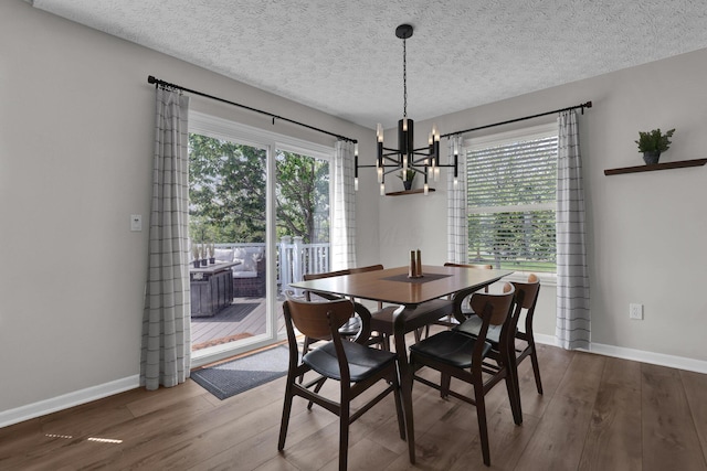 4215 Mack Ct, Powell, OH 43065 - dining room with a chandelier, wood finished floors, baseboards, and a textured ceiling