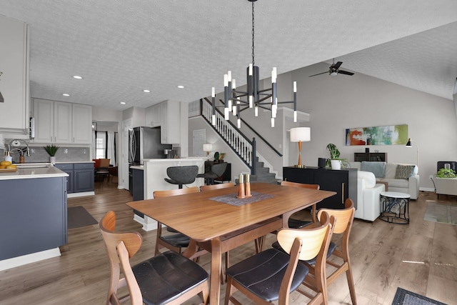 4215 Mack Ct, Powell, OH 43065 - dining area with light wood-style floors, recessed lighting, a ceiling fan, stairs, and a textured ceiling