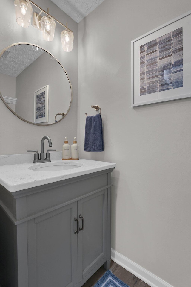 4215 Mack Ct, Powell, OH 43065 - bathroom featuring wood finished floors, baseboards, vanity, and a textured ceiling