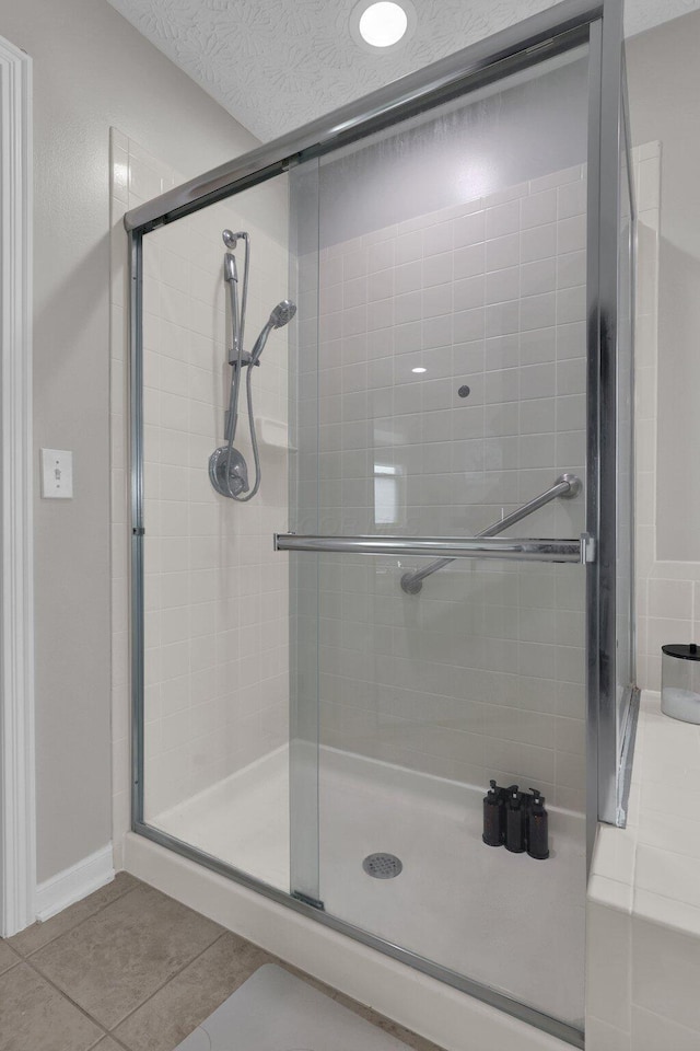 4215 Mack Ct, Powell, OH 43065 - bathroom featuring tile patterned floors, a shower stall, a textured ceiling, and baseboards