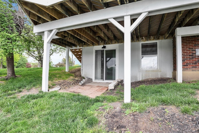 4215 Mack Ct, Powell, OH 43065 - view of exterior entry featuring a yard and brick siding