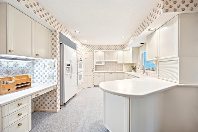 685 Dogwood Ln, Newark, OH 43055 - kitchen featuring white appliances, a peninsula, light carpet, light countertops, and decorative backsplash