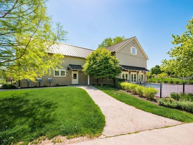 1211 Darcann Dr, Columbus, OH 43220 - view of front of property with board and batten siding, metal roof, and a standing seam roof