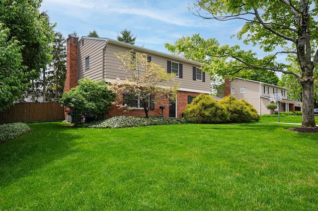 1211 Darcann Dr, Columbus, OH 43220 - colonial inspired home with a chimney, brick siding, and central AC unit
