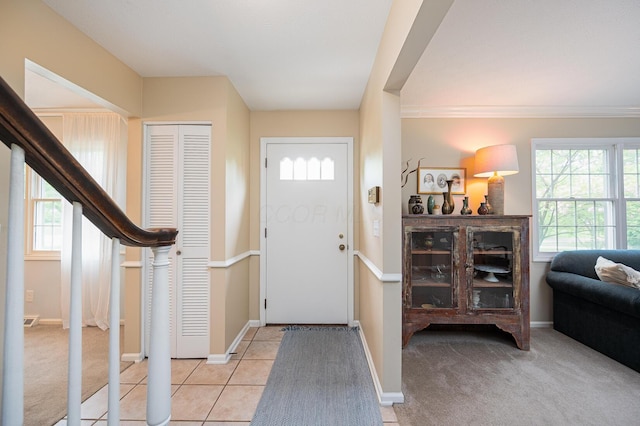 1211 Darcann Dr, Columbus, OH 43220 - foyer featuring healthy amount of natural light, baseboards, light tile patterned floors, and crown molding
