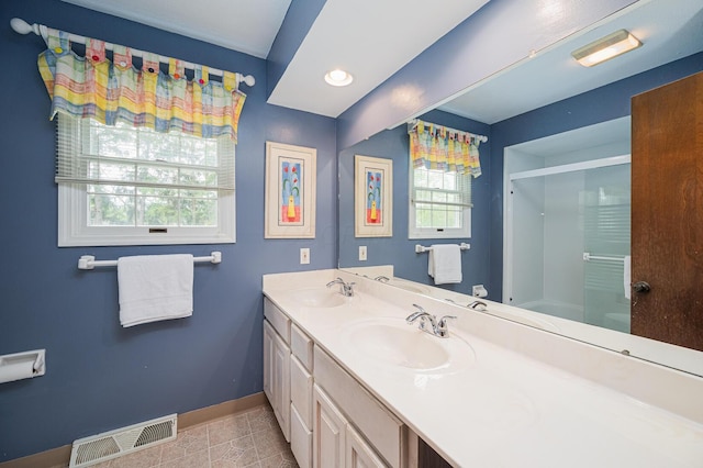 1211 Darcann Dr, Columbus, OH 43220 - bathroom featuring baseboards, a shower with door, double vanity, and tile patterned floors