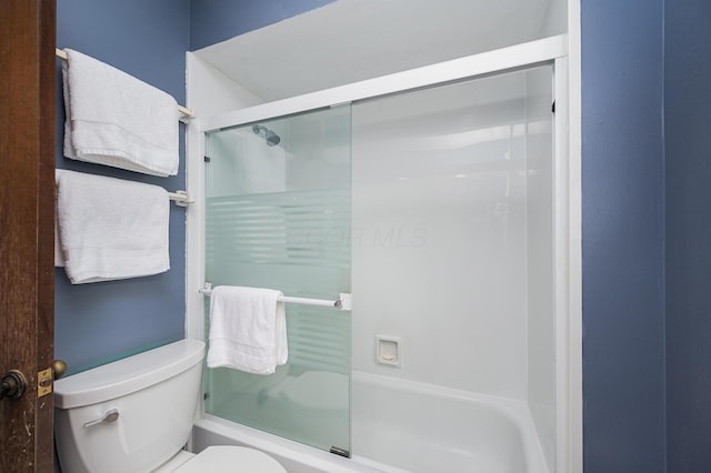 1211 Darcann Dr, Columbus, OH 43220 - bathroom featuring toilet and bath / shower combo with glass door