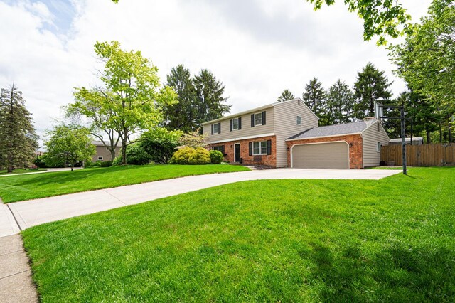 1211 Darcann Dr, Columbus, OH 43220 - colonial house with brick siding, concrete driveway, and an attached garage