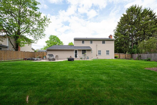 1211 Darcann Dr, Columbus, OH 43220 - back of property with a patio and a chimney