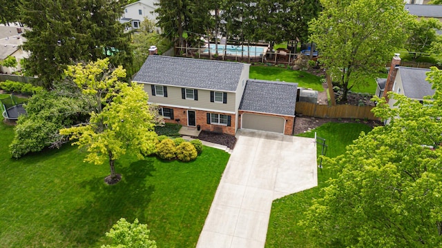 1211 Darcann Dr, Columbus, OH 43220 - view of front of property featuring brick siding, concrete driveway, an attached garage, and a shingled roof