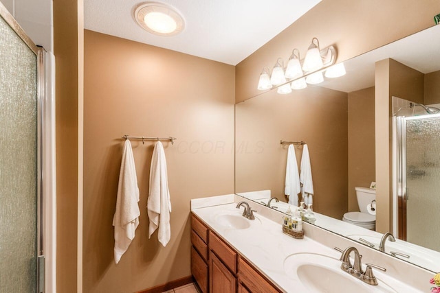 2040 Riggs Rd, Newark, OH 43055 - bathroom featuring toilet, a stall shower, and double vanity