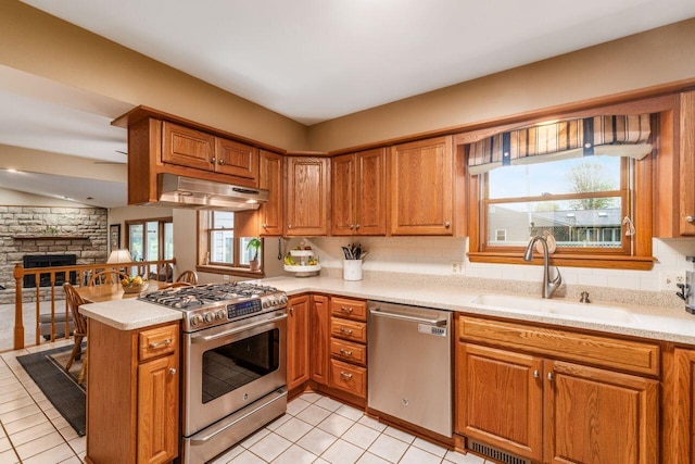 2040 Riggs Rd, Newark, OH 43055 - kitchen with appliances with stainless steel finishes, under cabinet range hood, a sink, a peninsula, and light countertops