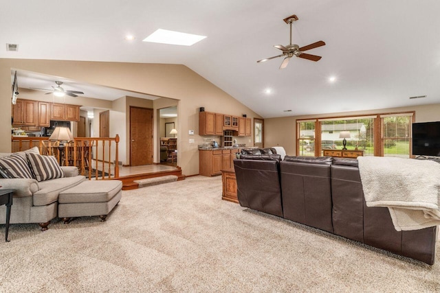 2040 Riggs Rd, Newark, OH 43055 - living room with a ceiling fan, vaulted ceiling, light colored carpet, and a skylight