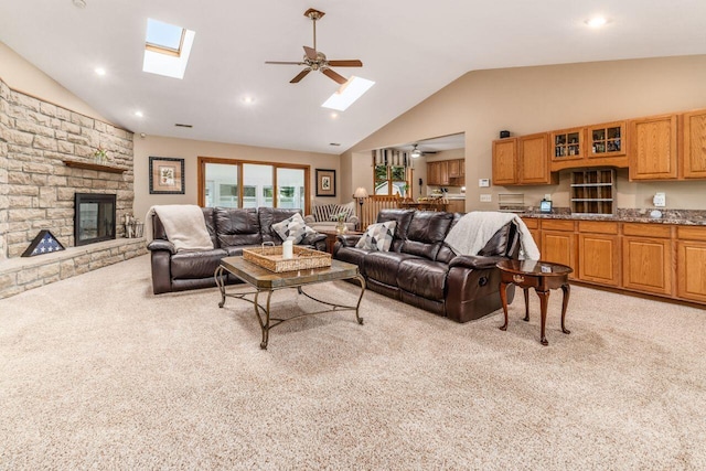 2040 Riggs Rd, Newark, OH 43055 - living area with a skylight, light colored carpet, a ceiling fan, a stone fireplace, and high vaulted ceiling
