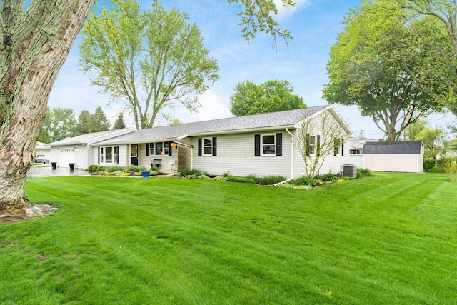 2040 Riggs Rd, Newark, OH 43055 - view of front of home with an attached garage, a front yard, a storage shed, and an outbuilding