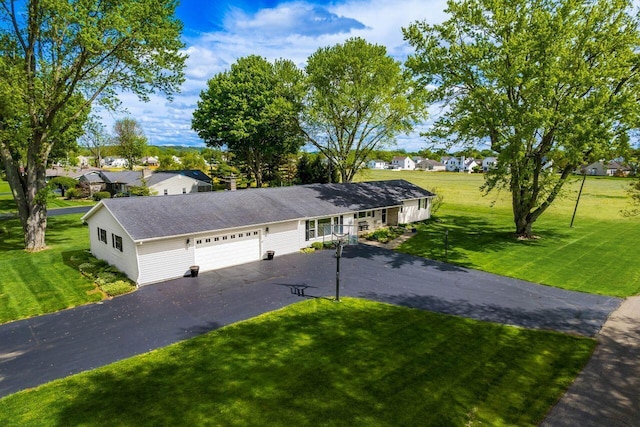 2040 Riggs Rd, Newark, OH 43055 - ranch-style home featuring a garage, driveway, a front yard, and a residential view