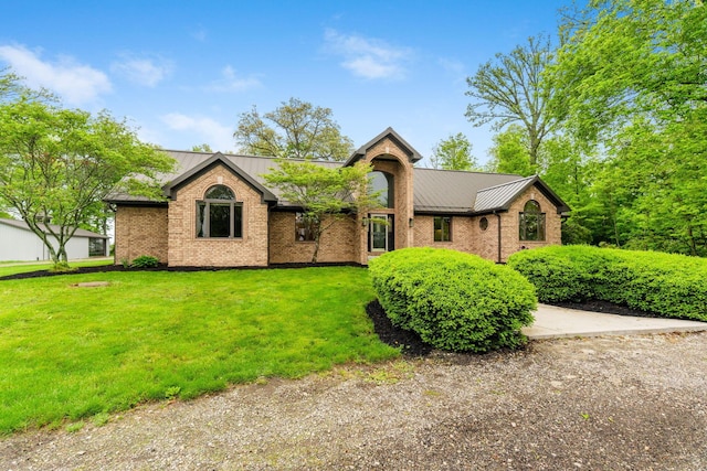 3100 Kropp Rd, Grove City, OH 43123 - view of front of house featuring a front lawn, a standing seam roof, brick siding, and metal roof