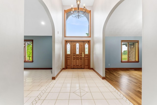 3100 Kropp Rd, Grove City, OH 43123 - entrance foyer featuring arched walkways, a chandelier, a high ceiling, and baseboards