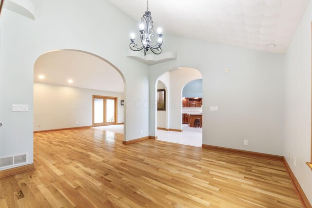 3100 Kropp Rd, Grove City, OH 43123 - unfurnished room featuring arched walkways, light wood finished floors, high vaulted ceiling, a chandelier, and recessed lighting