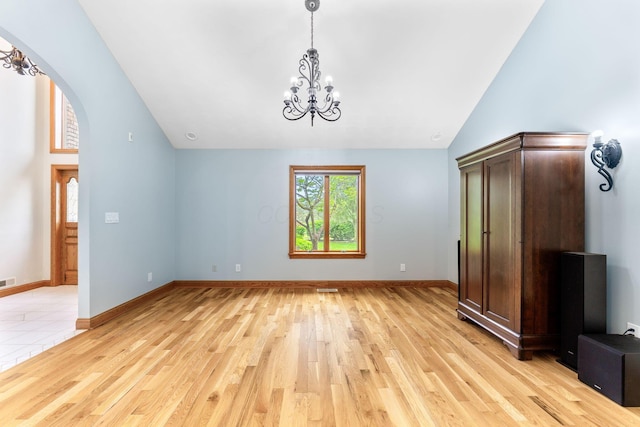 3100 Kropp Rd, Grove City, OH 43123 - unfurnished bedroom featuring a chandelier, light wood finished floors, arched walkways, baseboards, and high vaulted ceiling