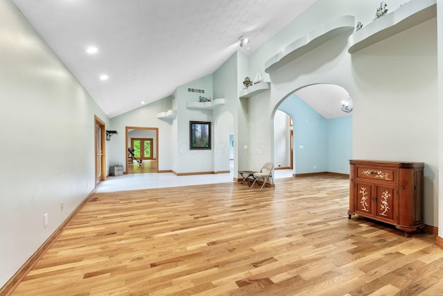 3100 Kropp Rd, Grove City, OH 43123 - unfurnished living room featuring light wood-type flooring, arched walkways, high vaulted ceiling, baseboards, and recessed lighting