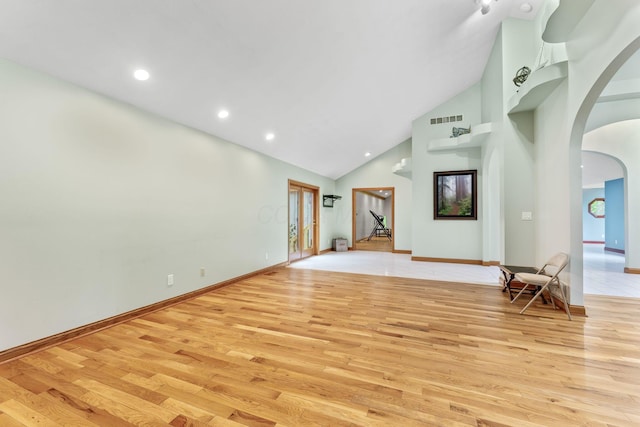 3100 Kropp Rd, Grove City, OH 43123 - unfurnished living room featuring arched walkways, light wood-type flooring, high vaulted ceiling, baseboards, and recessed lighting