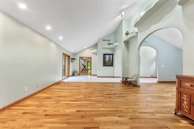 3100 Kropp Rd, Grove City, OH 43123 - unfurnished living room featuring light wood-type flooring, arched walkways, high vaulted ceiling, baseboards, and recessed lighting