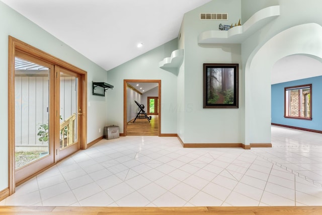 3100 Kropp Rd, Grove City, OH 43123 - empty room with light tile patterned floors, baseboards, arched walkways, recessed lighting, and high vaulted ceiling