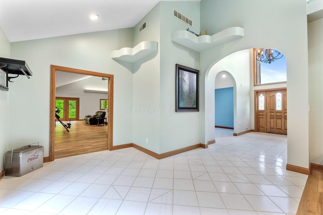 3100 Kropp Rd, Grove City, OH 43123 - foyer entrance with high vaulted ceiling, arched walkways, baseboards, light tile patterned floors, and a chandelier