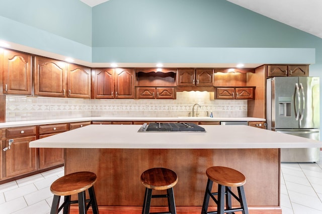 3100 Kropp Rd, Grove City, OH 43123 - kitchen with stainless steel fridge with ice dispenser, gas stovetop, a sink, light tile patterned floors, and a center island