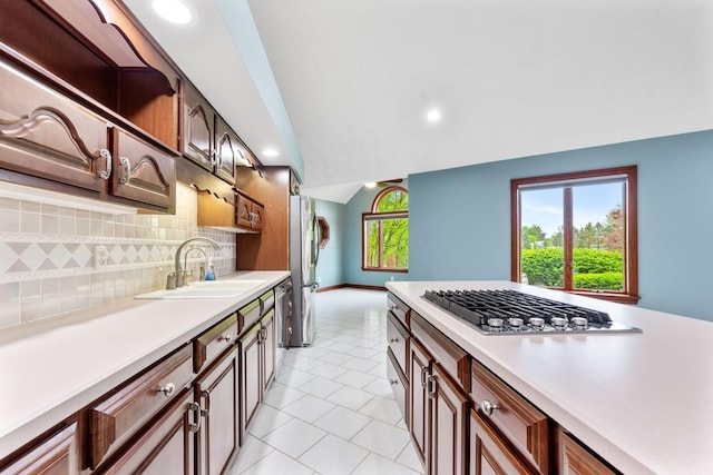 3100 Kropp Rd, Grove City, OH 43123 - kitchen featuring a sink, appliances with stainless steel finishes, backsplash, light countertops, and lofted ceiling