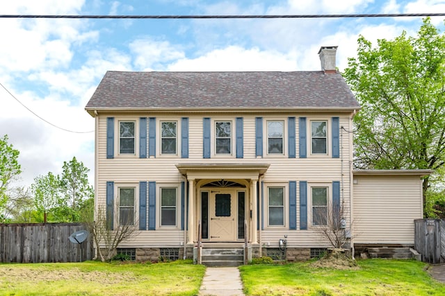colonial-style house featuring a chimney