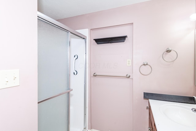 full bath featuring vanity and a shower stall