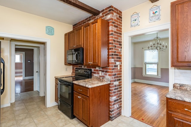 kitchen featuring black appliances, brown cabinetry, baseboards, a chandelier, and light stone counters