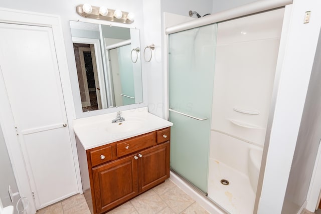 bathroom featuring a shower stall and vanity
