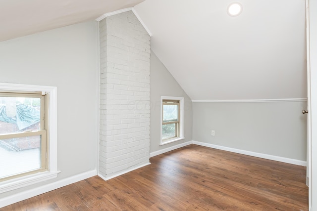bonus room featuring vaulted ceiling, baseboards, and wood finished floors
